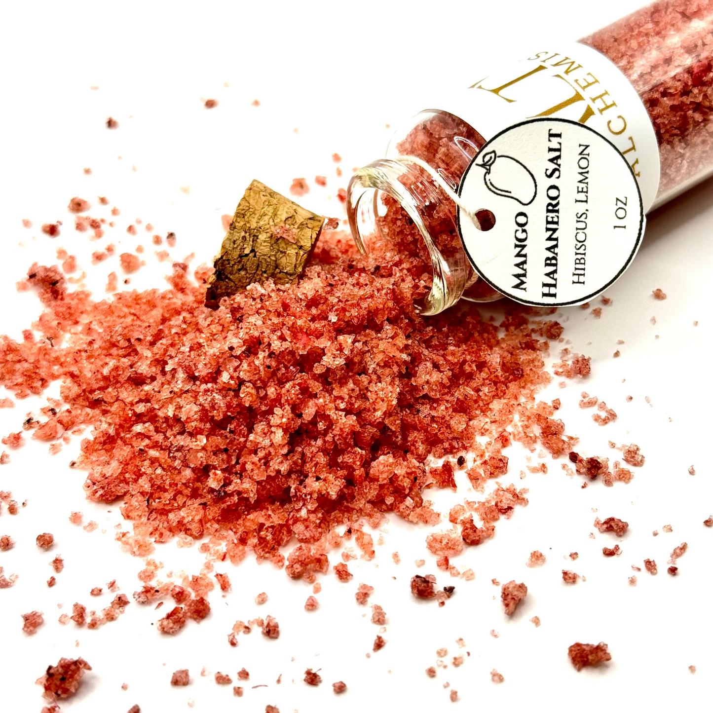 Mango Habanero Salt bottle with salt spilling out on a white background